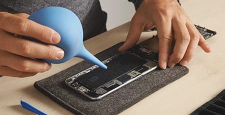 Phone repairing with a screw driver.